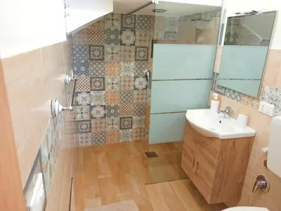 a bathroom with a sink and a shower at Le notti di Nettuno a Isola Delle Femmine in Isola delle Femmine