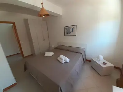 a bedroom with a bed with two towels on it at Residenza sabbia dorata in Alcamo