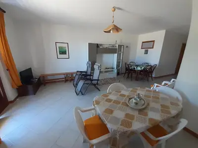 a living room with a table and chairs at Residenza sabbia dorata in Alcamo