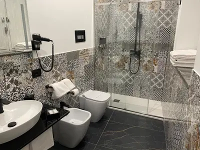 a bathroom with a shower and a toilet and a sink at Case vacanze donna Ina in Palermo