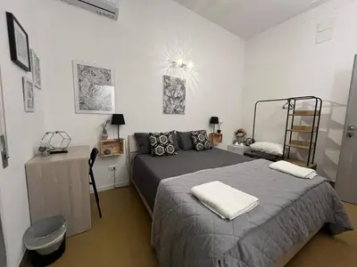 a bedroom with a bed and a dresser in it at Donizetti 19 in Palermo