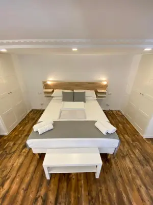 a room with three beds and a wooden floor at SuiteInPalermo - case vacanze nel centro storico in Palermo