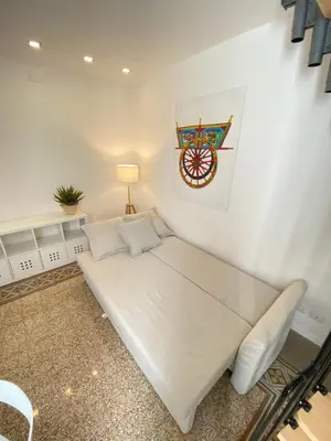 a white bed in a room with a lamp at SuiteInPalermo - case vacanze nel centro storico in Palermo