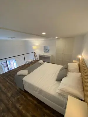 a bedroom with a large bed with pillows on it at SuiteInPalermo - case vacanze nel centro storico in Palermo