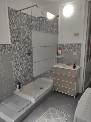 a bathroom with a shower with a tub and a sink at CASA DEI SOGNI in Palermo
