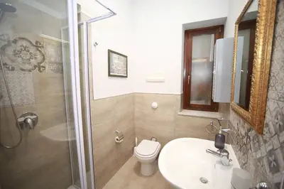 a bathroom with a toilet and a sink and a shower at Appartamento con terrazza al centro storico. in Palermo