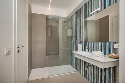 a bathroom with a shower and a sink at Villa Maria con piscina e vista mare in Castellammare del Golfo