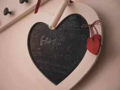 a heart clock with a chalkboard on a wall at Itiseasy Palermo 1 e 2 Private Apartments in Palermo