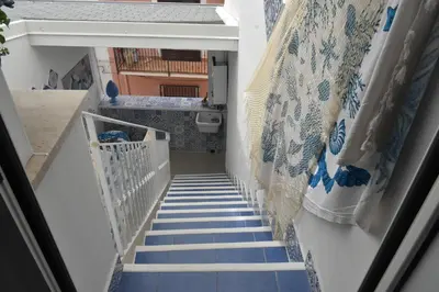 a stairway with blue and white stairs with blue and white tiles at MARINA BAY in Terrasini