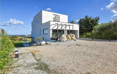 a white house on a gravel driveway at 5 Bedroom Nice Home In Trappeto in Trappeto