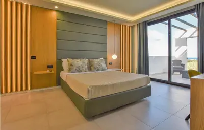 a bedroom with a bed and a large window at 5 Bedroom Nice Home In Trappeto in Trappeto
