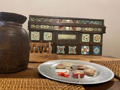 a plate of food on a table with a vase at Casa Vetriera in Palermo