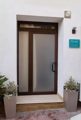 a front door of a building with two plants at Christian Guest House in Terrasini