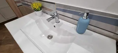 a white bathroom sink with a blue bottle on it at Christian Guest House in Terrasini