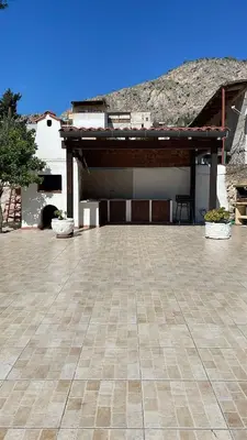 a large patio with a building with a roof at Campofelice Casa vacanza in Palermo