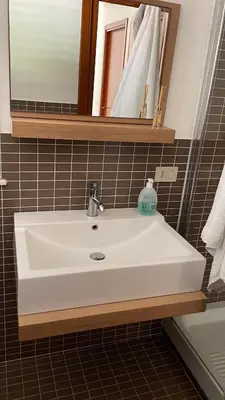 a white sink in a bathroom with a mirror at Campofelice Casa vacanza in Palermo