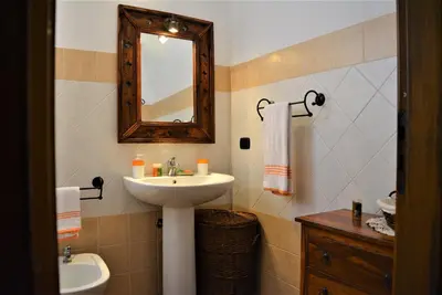 a bathroom with a sink and a mirror at Casa Bouganville in Scopello