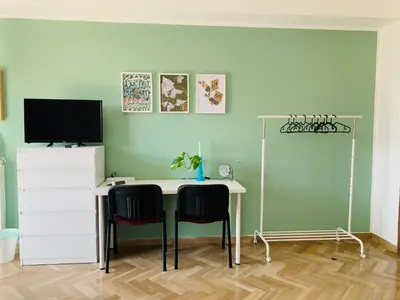 a room with a desk with two chairs and a television at Sostegno d'amore in Palermo
