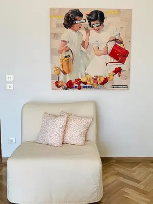 a white couch in a room with a picture on the wall at Sostegno d'amore in Palermo