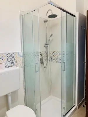 a shower with a glass door in a bathroom at Sostegno d'amore in Palermo