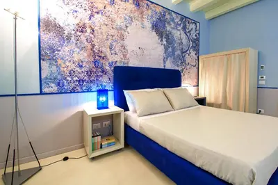 a bedroom with a bed and a painting on the wall at CELSO 14 in Palermo