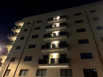 a tall white building with balconies at night at Balsamotto - Appartamento e parcheggio in Palermo