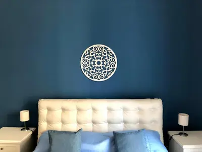 a blue wall with a white plate above a bed at Essenze di Sicilia Appartamento Cavour in centro in Palermo