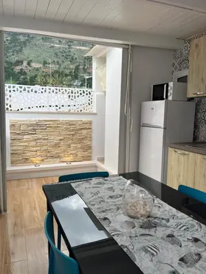 a kitchen with a table and chairs and a window at Home holiday Kalanto in Castellammare del Golfo