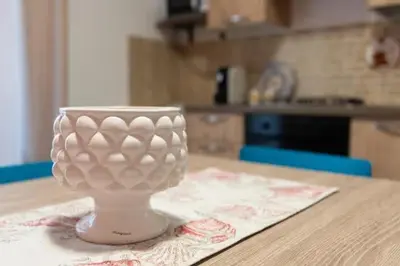 a white vase sitting on top of a table at Home holiday Kalanto in Castellammare del Golfo
