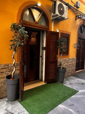 an entrance to a building with a green lawn at Casa vacanze Loft del Borgo in Palermo
