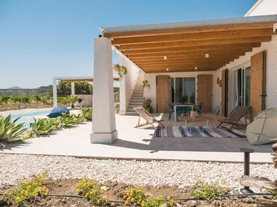 a house with a patio and a swimming pool at VILLA DELLA QUBBAH with pool in Alcamo