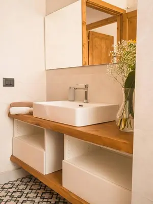 a bathroom with a sink and a mirror at VILLA DELLA QUBBAH with pool in Alcamo