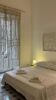 a bedroom with a large bed with towels on it at DonnaFrancaFlorio in Palermo