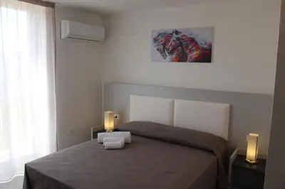 a bedroom with a bed with two candles on it at Rahal B&B in Palermo
