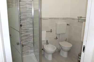 a bathroom with a toilet and a sink at Rahal B&B in Palermo