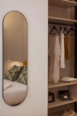 a mirror in front of a bedroom with a bed at NITI Palace in Castellammare del Golfo