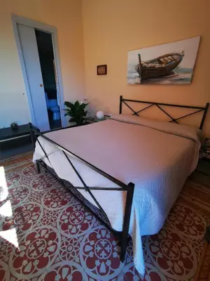 a bedroom with a bed in a room at La Dimora del Massimo in Palermo