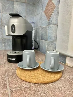 two coffee cups on a counter next to a coffee maker at Casa Kilò in Palermo