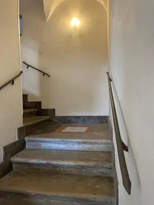 a hallway with stairs with a light on the wall at Casa Kilò in Palermo