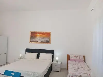 a bedroom with two beds and a bedskirts at Villa Rosa in Castellammare del Golfo