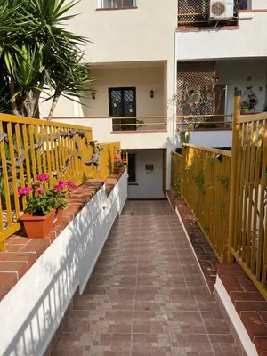 a walkway outside of a house with flowers inpots at Trentuno Mondello Apartments in Mondello