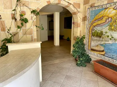 a hallway in a building with a mural on the wall at La Casa di Martorana in Palermo