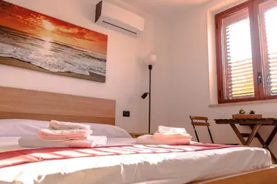a bedroom with a bed with two towels on it at Casa Vespucci in Isola delle Femmine