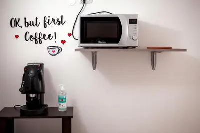 a microwave sitting on a shelf on a wall at Pindemonte Suites in Palermo