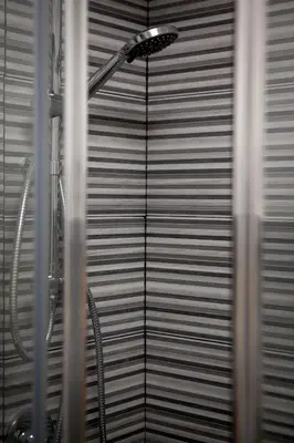 a shower in a bathroom with a window at Pindemonte Suites in Palermo