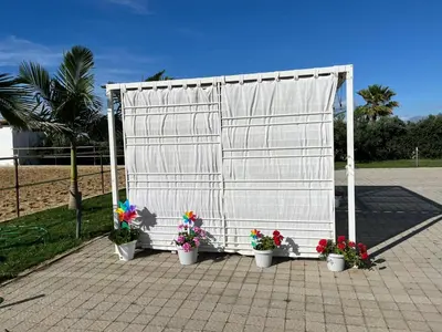 a white structure with three potted flowers in buckets at Casa RALIVO di Sicilia in Balestrate