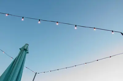 a string of lights on top of a pole at DAI MORI in Palermo