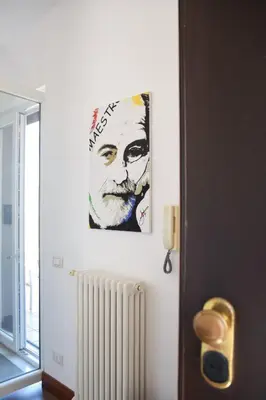 a painting of a man with a beard on a wall at A Casa Dell' Artista in Palermo