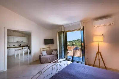 a room with a balcony with a couch and a table at Bianca Casa in Bolognetta