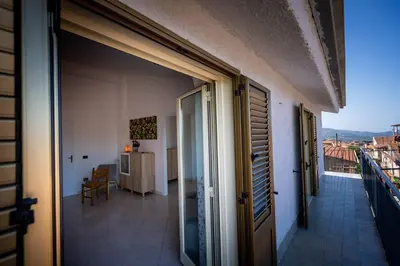 an open door of a building with a balcony at Bianca Casa in Bolognetta